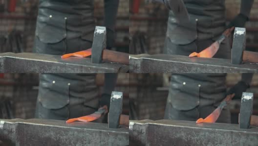 铁匠在铁匠铺手工锻造熔化的金属高清在线视频素材下载
