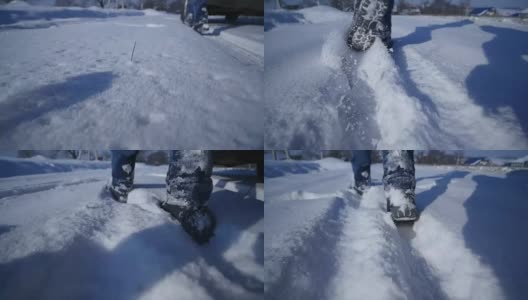 双脚在深雪中行走的慢镜头。徒步旅行者的脚步。冬季户外休闲活动高清在线视频素材下载