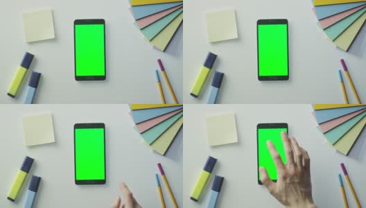 设计师正在使用Android手机与绿色屏幕在肖像模式。前视图。高清在线视频素材下载