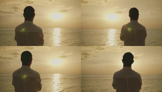 斯坦尼康镜头:孤独的男人期待着海面上的日落。后视图。浪漫和海上度假。4K慢动作视频高清在线视频素材下载