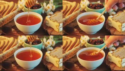 乡村餐桌上的蜜罐和长柄勺，面包，葡萄干，洋甘菊花和蜂窝高清在线视频素材下载