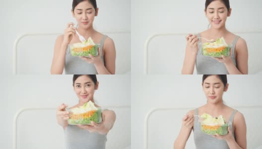 美丽的亚洲女孩吃解毒蔬菜和水果。漂亮女孩拿着水果沙拉和排毒食品。健身、保健、饮食的概念。高清在线视频素材下载