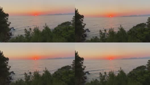 日落在地中海地平线上的岩石，松树。高清在线视频素材下载