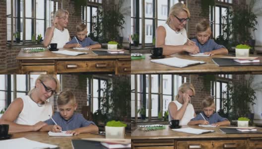 奶奶在家里的办公室里帮助一个男生复习功课。这个十几岁的男孩和一位中年老师完成了学校布置的一项家庭作业高清在线视频素材下载