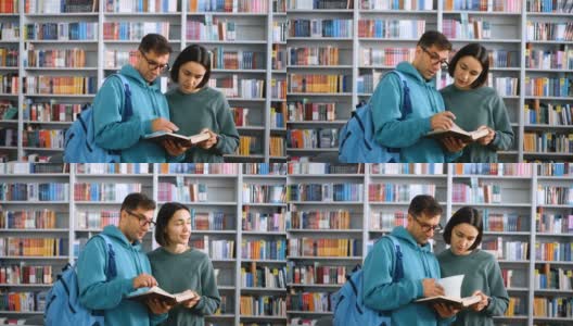 一名戴着眼镜的千禧一代年轻学生和一名年轻貌美的女学生站在图书馆书架的背景下看书备考。概念高清在线视频素材下载