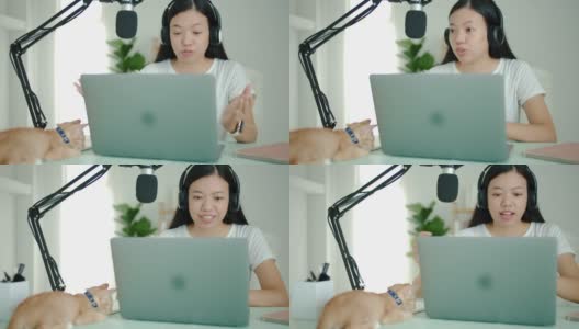 亚洲女学生或女商人远程工作与电脑和小猫。社交距离概念在covid-19疫情下独自在家工作。高清在线视频素材下载
