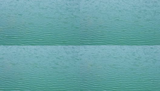 无缝无人机在碧绿的湖水涟漪接近视图。鸟瞰图的海或海洋与美丽的波浪图案的景观，无尽的海蓝宝石水在夏天的日子高清在线视频素材下载