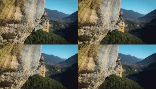 女攀岩者正在学习爬绳，寻找天然墙壁上的落点。股票视频高清在线视频素材下载