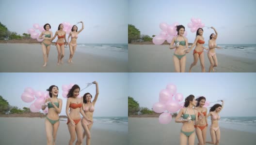 一群快乐的女孩朋友拿着五颜六色的气球在沙滩上奔跑，带着快乐的情绪。有聚会庆祝观念的人。4 k决议。慢动作镜头。高清在线视频素材下载