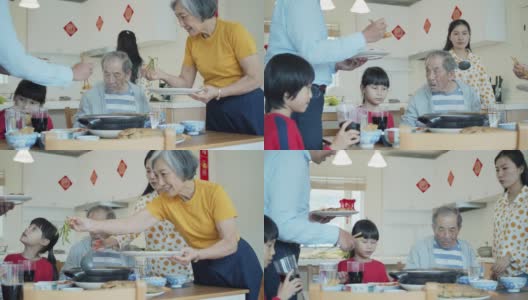 父亲和祖母在春节给家人上菜高清在线视频素材下载