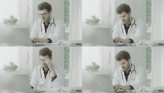 医生在笔记本电脑上学习治疗方法高清在线视频素材下载