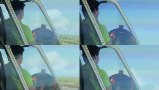 男飞行员驾驶轻型运动飞机，用方向盘操纵高清在线视频素材下载