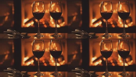 Cinemagraph -两个红酒酒杯在壁炉的背景。高清在线视频素材下载