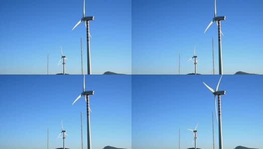 在春天晴朗的天空下，风力涡轮机。意大利撒丁岛高清在线视频素材下载