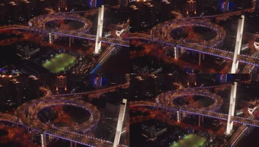 航拍南浦大桥螺旋路交通场景，夜间日落时间与陆上交通概念，中国上海，4k视频高清在线视频素材下载