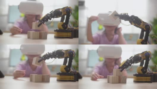 女孩控制与机械机器人手臂使用VR眼镜高清在线视频素材下载