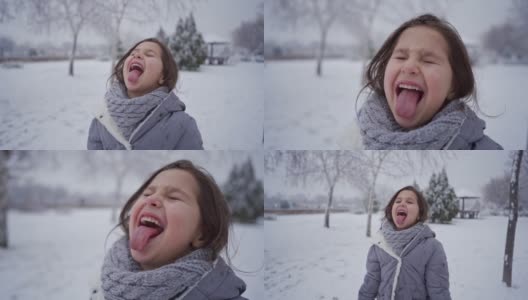 顽皮可爱的女孩在下雪的时候伸出舌头高清在线视频素材下载