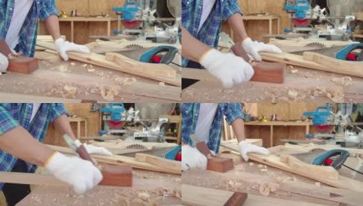 木匠正在用刨床。男木匠在木工车间使用刨床。高清在线视频素材下载
