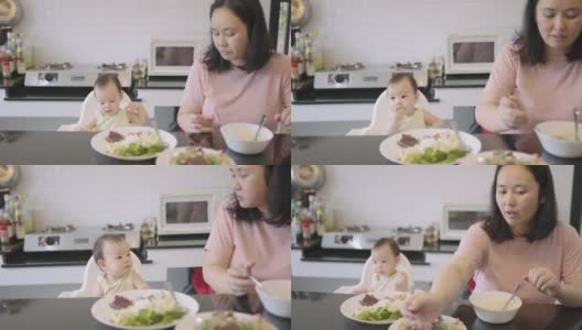 亚裔泰国妈妈和她的孩子吃饭高清在线视频素材下载