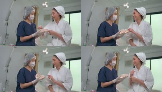 女性整形外科医生向病人展示硅胶乳房植入物高清在线视频素材下载