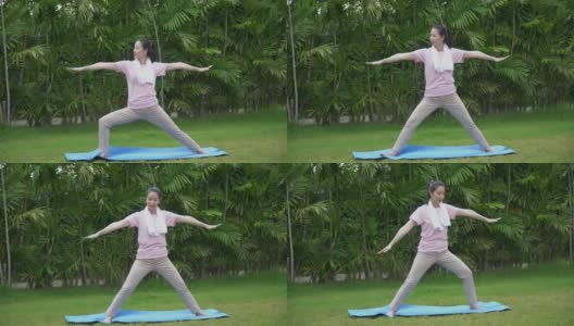 年轻的亚洲健身女子练习瑜伽伸展她的腿，以暖身坐在垫在公园早上。运动适合女孩锻炼或锻炼训练后院在家里的生活方式的概念高清在线视频素材下载
