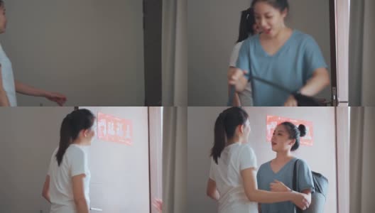 一位亚洲华人女子打开门，欢迎她的朋友在周末休闲时间一起到她家练习瑜伽高清在线视频素材下载