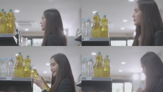 亚洲妇女正在购买植物油高清在线视频素材下载