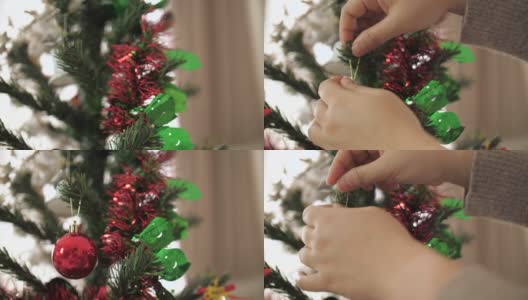 小女孩在圣诞节用装饰品装饰圣诞树高清在线视频素材下载