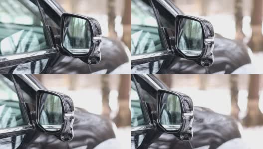 侧视摄像头安装在一辆黑色轿车的侧视镜上。360度全方位摄像头。新技术。现代汽车技术。高清在线视频素材下载