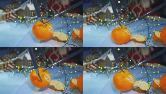 人形机器人在为圣诞节做准备时剥橘子皮。裁剪的观点。计算机的概念高清在线视频素材下载