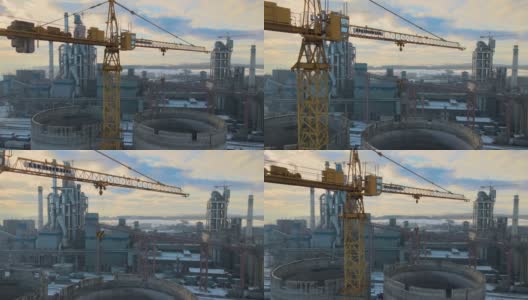 日落时分，工业生产区的水泥厂鸟瞰图，厂房结构高大，塔式起重机。高清在线视频素材下载