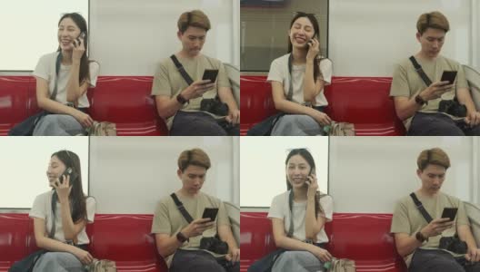 亚洲女性游客用手机聊天，乘坐火车在城市视野中穿梭。高清在线视频素材下载