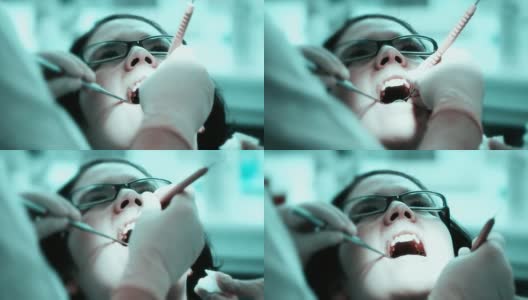 年轻女子在牙科诊所，牙科手术，处理牙齿(HD720p)高清在线视频素材下载