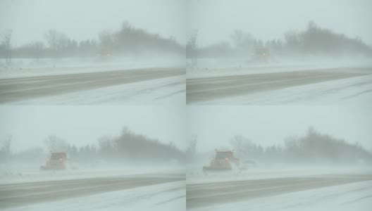 冬季暴风雪与吹雪横跨高速公路，扫雪机和车辆高清在线视频素材下载