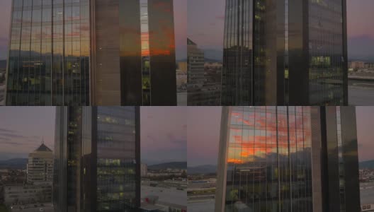 天线:日落时分在商业摩天大楼周围飞行高清在线视频素材下载