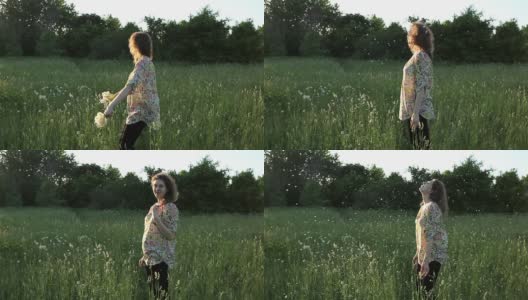 女孩在草地上玩蒲公英高清在线视频素材下载