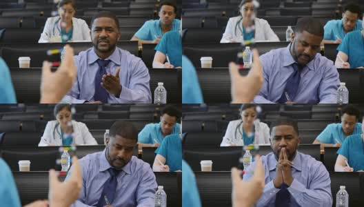 非裔美国男性医疗保健专业人士向医学会议发言人提问高清在线视频素材下载