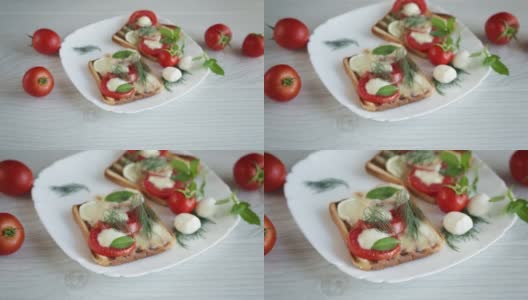 热烤面包配马苏里拉奶酪和西红柿高清在线视频素材下载