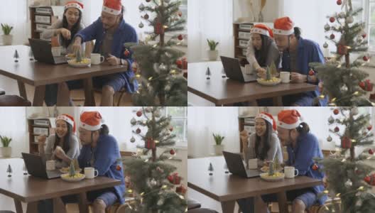 年轻的亚洲夫妇通过在线视频通话庆祝圣诞节。在冠状病毒隔离期间保持社交距离和自我隔离高清在线视频素材下载
