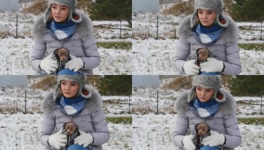 忧心忡忡的女人在冬天照顾小狗高清在线视频素材下载