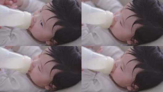 在家里用奶瓶喂亚洲男婴高清在线视频素材下载