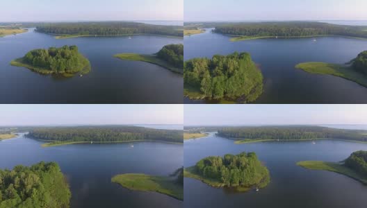 鸟瞰图绿色岛屿和云在夏天阳光明媚的早晨。波兰的马苏里安湖区。从上面看世界奇观。高清在线视频素材下载