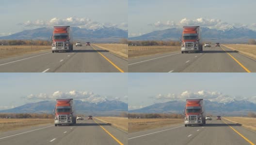 特写:半卡车沿着高速公路行驶，经过农田和牧场高清在线视频素材下载