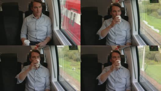 商务人士在火车上舒适地坐着，一边喝着咖啡，一边欣赏窗外的景色高清在线视频素材下载