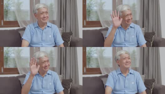 肖像亚洲华人老人在家里开心的微笑。早上躺在家里客厅的沙发上，年长的男性对着镜头放松牙齿微笑的概念。高清在线视频素材下载