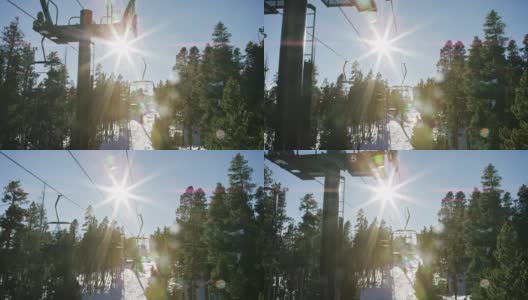 滑雪运动员在博尔德附近的埃尔多拉滑雪度假村滑雪缆车的慢动作拍摄，在一个晴朗，阳光明媚的日子高清在线视频素材下载
