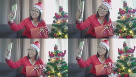 一位亚裔女性圣诞节在家和家人视频通话高清在线视频素材下载
