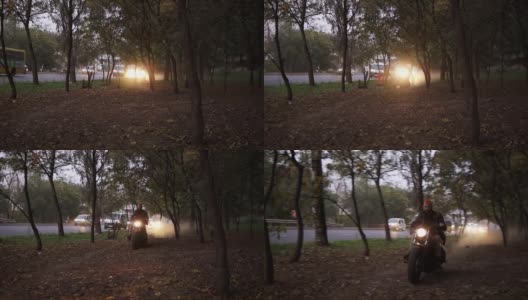 一个男人骑着摩托车穿过树林的正面高清在线视频素材下载