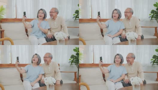 亚洲美丽的老女人和老男人夫妇在家里用手机和儿子、女儿视频通话，和孙子孙女聊天。祖父母对通过互联网交流感到高兴高清在线视频素材下载