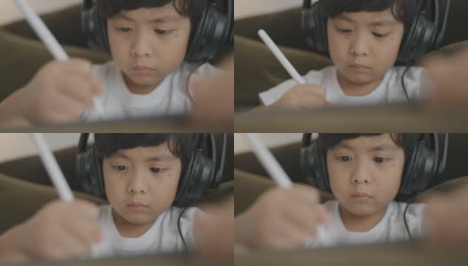 亚洲男孩数字艺术家绘画在一个图形平板电脑。高清在线视频素材下载